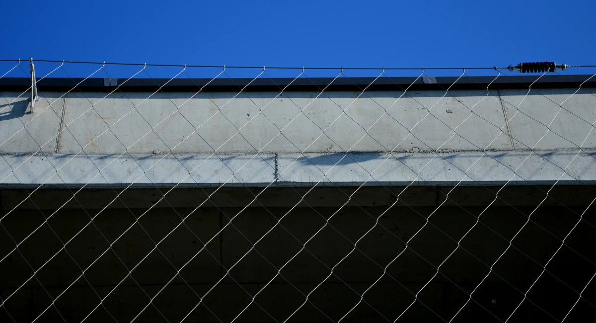 Tension cable barrier across a building