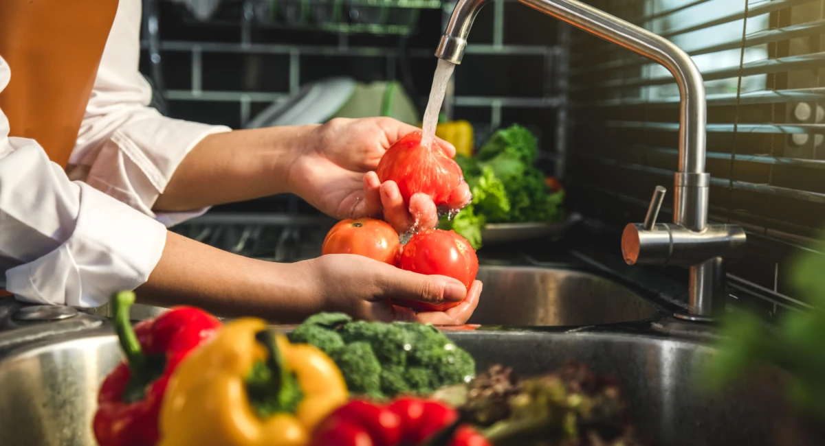 Fruits and vegetable getting washed in sink