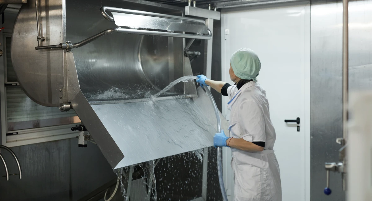 Female Worker Washing Tank at Cheese and Dairy Factory
